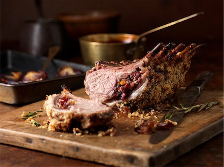 Christmas dinner. Lamb rack rare medium with cranberry and clementine stuffing and rosemary Stock Photo - Premium Royalty-Free, Code: 649-07804837