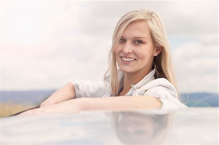 simsearch:649-07280823,k - Young woman smiling beside car Stock Photo - Premium Royalty-Free, Code: 649-07804879