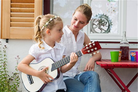 simsearch:649-07805043,k - Girl playing guitar with mother Stock Photo - Premium Royalty-Free, Code: 649-07805057