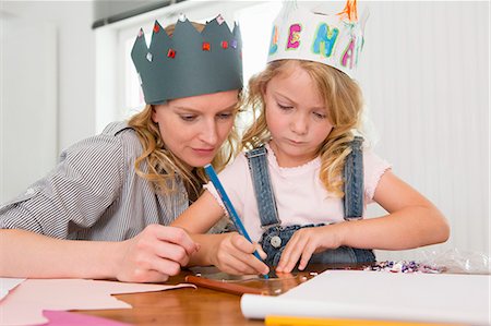 simsearch:649-07805043,k - Mother and daughter making paper crowns Stock Photo - Premium Royalty-Free, Code: 649-07805115