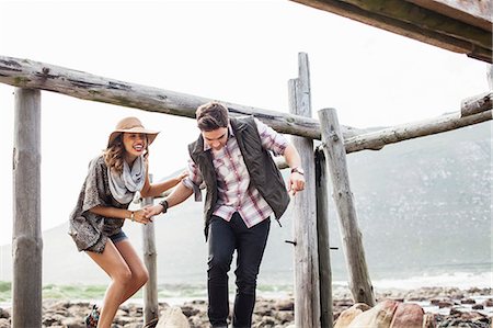 Young couple ducking under old pier, Cape Town, Western Cape, South Africa Photographie de stock - Premium Libres de Droits, Code: 649-07803285