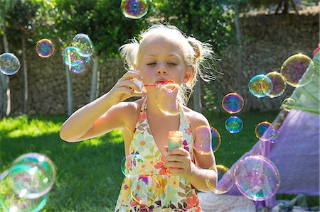 simsearch:649-06845253,k - Girls blowing bubbles in summer garden party Stock Photo - Premium Royalty-Free, Code: 649-07803880