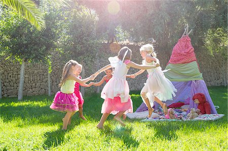 simsearch:649-07804176,k - Five girls in fairy costume playing in garden Stock Photo - Premium Royalty-Free, Code: 649-07803967