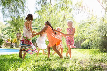 simsearch:649-07804176,k - Five girls playing ring a ring a roses in garden Stock Photo - Premium Royalty-Free, Code: 649-07803963