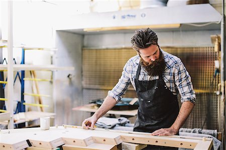 small business man not looking at camera - Cropped shot of mid adult craftsman measuring wood in organ workshop Stock Photo - Premium Royalty-Free, Code: 649-07905037