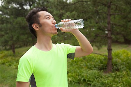 simsearch:400-04969467,k - Young male runner drinking bottled water in park Photographie de stock - Premium Libres de Droits, Code: 649-07905296