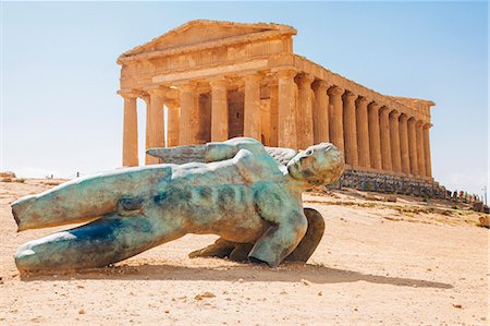 Modern sculpture of Icarus in front of the Temple of Concordia, Valley of the Temples, Sicily, Italy Stock Photo - Premium Royalty-Free, Code: 649-07905602