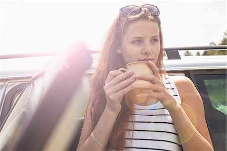 Young woman having coffee break on road trip Stock Photo - Premium Royalty-Free, Code: 649-07905743