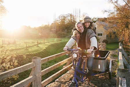 fall season people - Mature hippy couple on tricycle and trailer on rural road Stock Photo - Premium Royalty-Free, Code: 649-08004231
