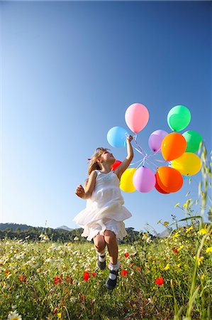 simsearch:649-08117852,k - Girl jumping for joy with colorful balloons in wildflower meadow, Majorca, Spain Foto de stock - Sin royalties Premium, Código: 649-08004262