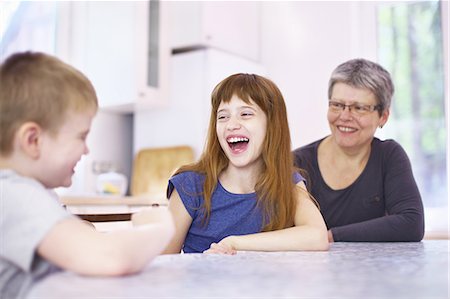 simsearch:614-07806393,k - Grandmother and grandchildren laughing at kitchen table Stock Photo - Premium Royalty-Free, Code: 649-08003900