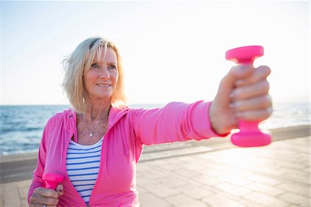 simsearch:649-07760822,k - Senior woman exercising with weights by beach Stock Photo - Premium Royalty-Free, Code: 649-08060121