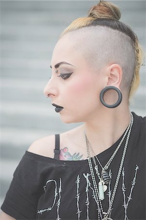 rebellious - Portrait of young female punk with piercings and shaved head Stock Photo - Premium Royalty-Free, Code: 649-08060320