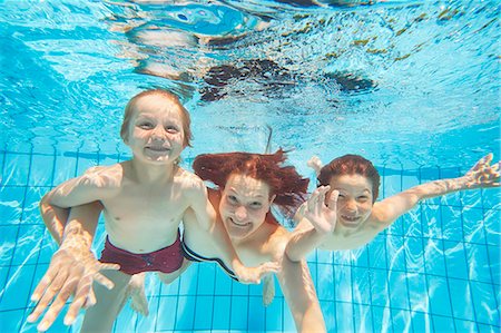 swimming, kids - Underwater view of mother and two sons diving in swimming pool Stock Photo - Premium Royalty-Free, Code: 649-08060617