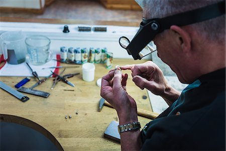 Jewellery craftsman touching platinum ring for smoothness Stock Photo - Premium Royalty-Free, Code: 649-08060758