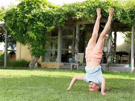 simsearch:649-07647801,k - Girl doing headstand in garden Stock Photo - Premium Royalty-Free, Code: 649-08060876
