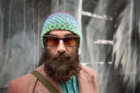Portrait of bearded mature man with beanie and sunglasses Stock Photo - Premium Royalty-Free, Code: 649-08084542