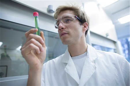 simsearch:649-08085222,k - Male scientist looking test tube in lab Stock Photo - Premium Royalty-Free, Code: 649-08084720