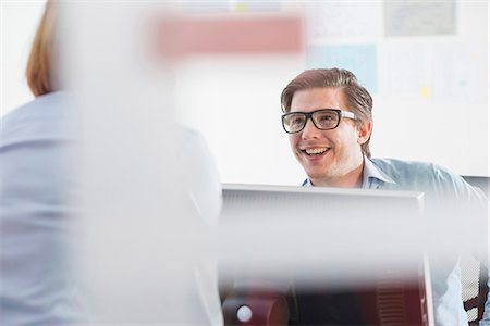 Businessman and woman chatting in office Stock Photo - Premium Royalty-Free, Code: 649-08084912