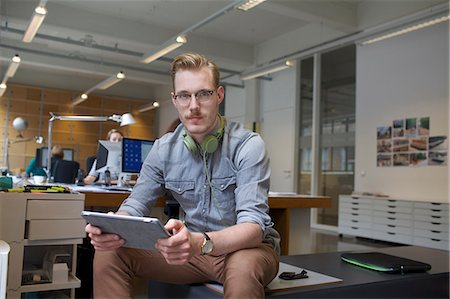 simsearch:649-07560130,k - Portrait of young man using digital tablet in office Stock Photo - Premium Royalty-Free, Code: 649-08084985