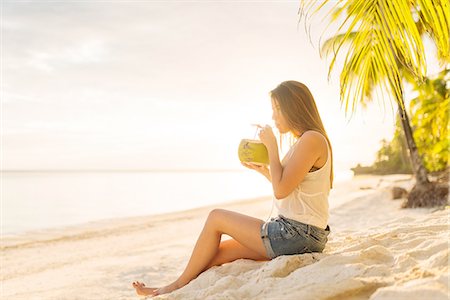 philippine people pictures - Young woman drinking fresh coconut milk on Anda beach, Bohol Province, Philippines Stock Photo - Premium Royalty-Free, Code: 649-08085679