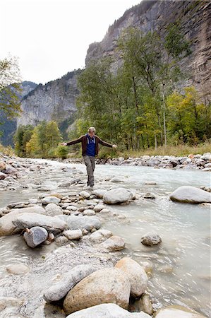 simsearch:649-08085723,k - Male hiker stepping over rocks in river, Grindelwald, Switzerland Foto de stock - Sin royalties Premium, Código: 649-08085704