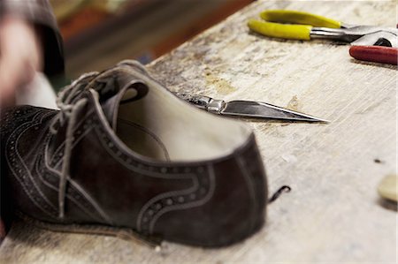 Close up of leather brogue and hand tools in shoe makers workshop Stock Photo - Premium Royalty-Free, Code: 649-08085833