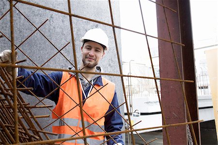 protective glove - Portrait of factory worker  selecting steel mesh at concrete reinforcement factory Stock Photo - Premium Royalty-Free, Code: 649-08086296