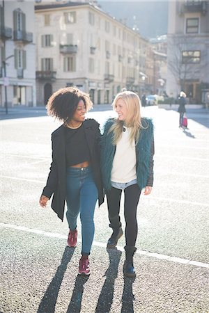 ringlet - Two female friends chatting and strolling in town square Stock Photo - Premium Royalty-Free, Code: 649-08086399