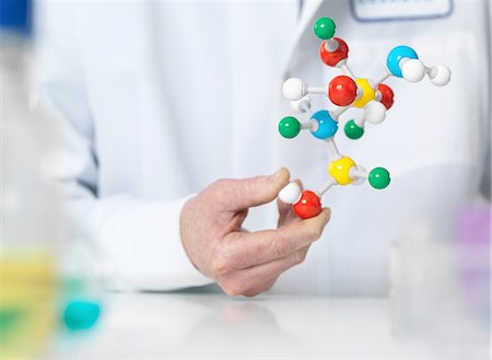Scientist holding a molecular model of a chemical formula Stock Photo - Premium Royalty-Free, Code: 649-08086434