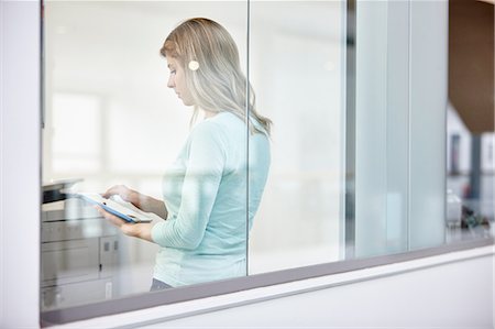 simsearch:649-07560130,k - Mid adult businesswoman using digital tablet behind office window Stock Photo - Premium Royalty-Free, Code: 649-08117801