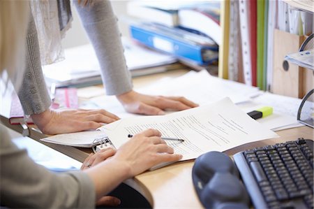 simsearch:649-07736470,k - Cropped shot of two businesswomen checking paperwork at office desk Stock Photo - Premium Royalty-Free, Code: 649-08117818