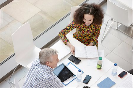 Overhead view of businessman and woman meeting at conference table Stock Photo - Premium Royalty-Free, Code: 649-08117822