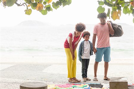 simsearch:649-07761247,k - Couple and son choosing clothes from sidewalk stall, Ipanema beach, Rio De Janeiro, Brazil Stock Photo - Premium Royalty-Free, Code: 649-08118014