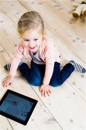 simsearch:649-07280729,k - Girl using digital tablet on wooden floor Stock Photo - Premium Royalty-Free, Code: 649-08118183