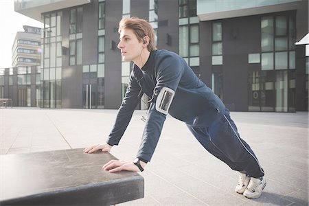 simsearch:693-07672615,k - Young male runner doing push ups on bench in city square Stock Photo - Premium Royalty-Free, Code: 649-08118834