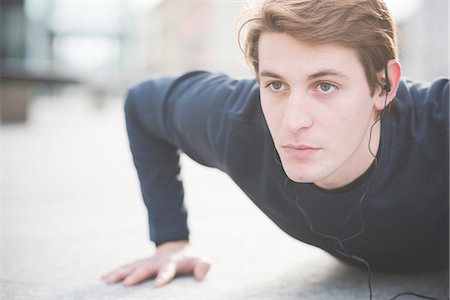 simsearch:693-07672615,k - Close up of young man doing press ups in city square Stock Photo - Premium Royalty-Free, Code: 649-08118839