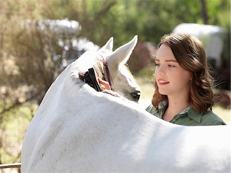 simsearch:649-07560533,k - Teenage girl grooming grey horse Photographie de stock - Premium Libres de Droits, Code: 649-08124930