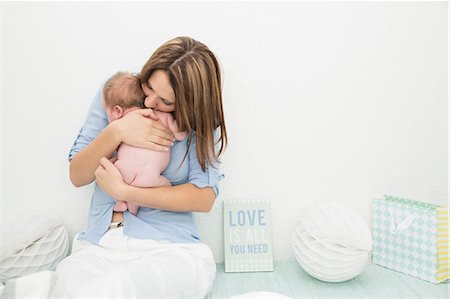 Mother cradling baby in arms Stock Photo - Premium Royalty-Free, Code: 649-08125138