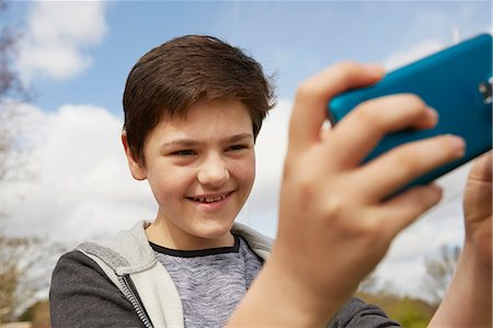 simsearch:649-07648247,k - Smiling teenage boy taking smartphone selfie Stock Photo - Premium Royalty-Free, Code: 649-08125598