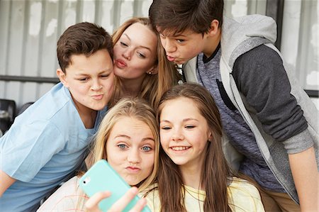 simsearch:649-07648247,k - Five boys and girls making faces for smartphone selfie in shelter Stock Photo - Premium Royalty-Free, Code: 649-08125590