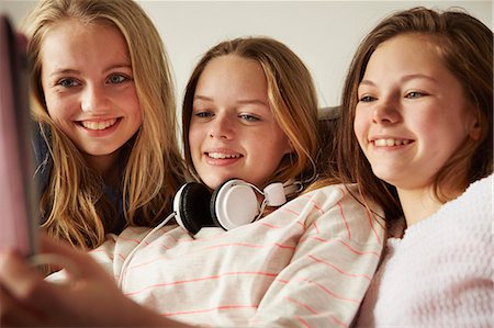simsearch:614-06442812,k - Three girls on sofa using digital tablet Stock Photo - Premium Royalty-Free, Code: 649-08125626