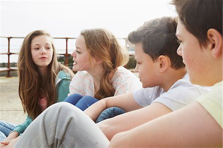 simsearch:649-07648247,k - Two boys and two girls sitting outside chatting Stock Photo - Premium Royalty-Free, Code: 649-08125632