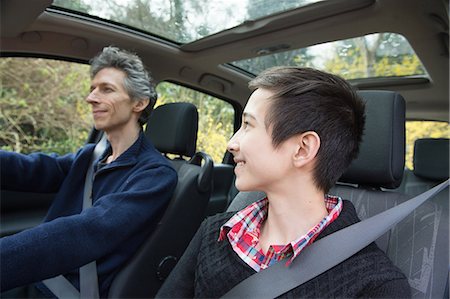 family inside car - Teenage boy looking at father whilst he drives car Stock Photo - Premium Royalty-Free, Code: 649-08125958