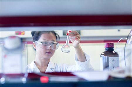 simsearch:649-08085222,k - Young female scientist  holding up volumetric flask in lab Stock Photo - Premium Royalty-Free, Code: 649-08126040
