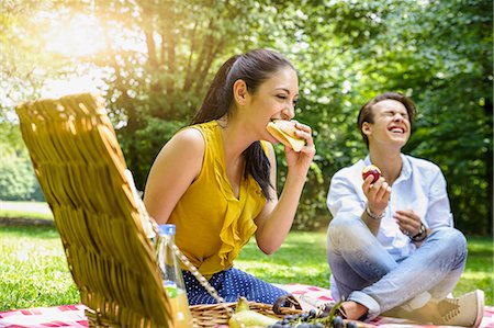 Young couple sitting eating picnic laughing Stock Photo - Premium Royalty-Free, Code: 649-08126092