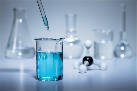 eye dropper - Chemistry research. A pipette transferring liquid to a beaker and a ball-and-stick molecular model Stock Photo - Premium Royalty-Free, Code: 649-08144172