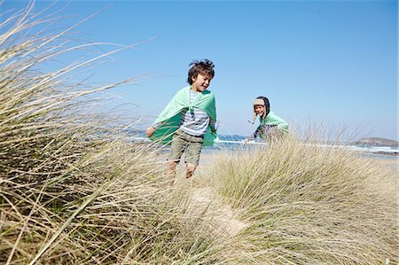 simsearch:649-07761212,k - Two young boys, wearing fancy dress, playing on beach Stock Photo - Premium Royalty-Free, Code: 649-08144180