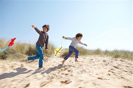 summer picture with kite - Two young boys, flying kites on beach Stock Photo - Premium Royalty-Free, Code: 649-08144194