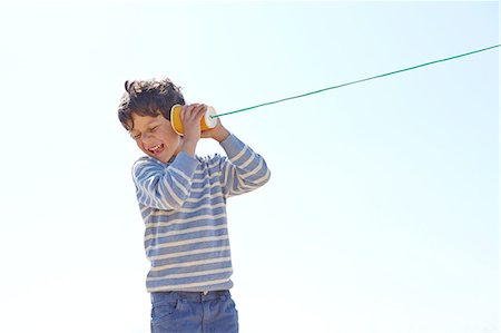 simsearch:649-06845253,k - Young boy, holding cup and string telephone to ear Stock Photo - Premium Royalty-Free, Code: 649-08144198